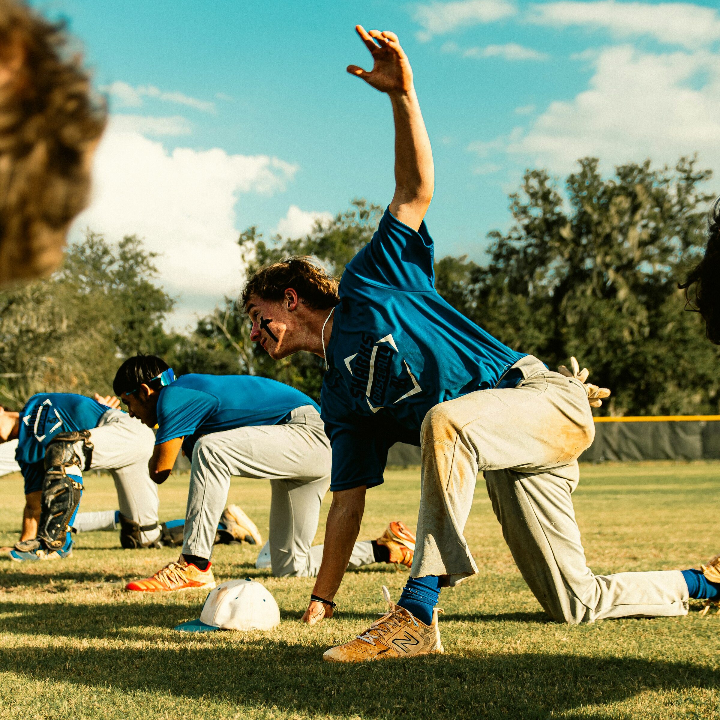 High school athletes engaging in team-based strength training for baseball.